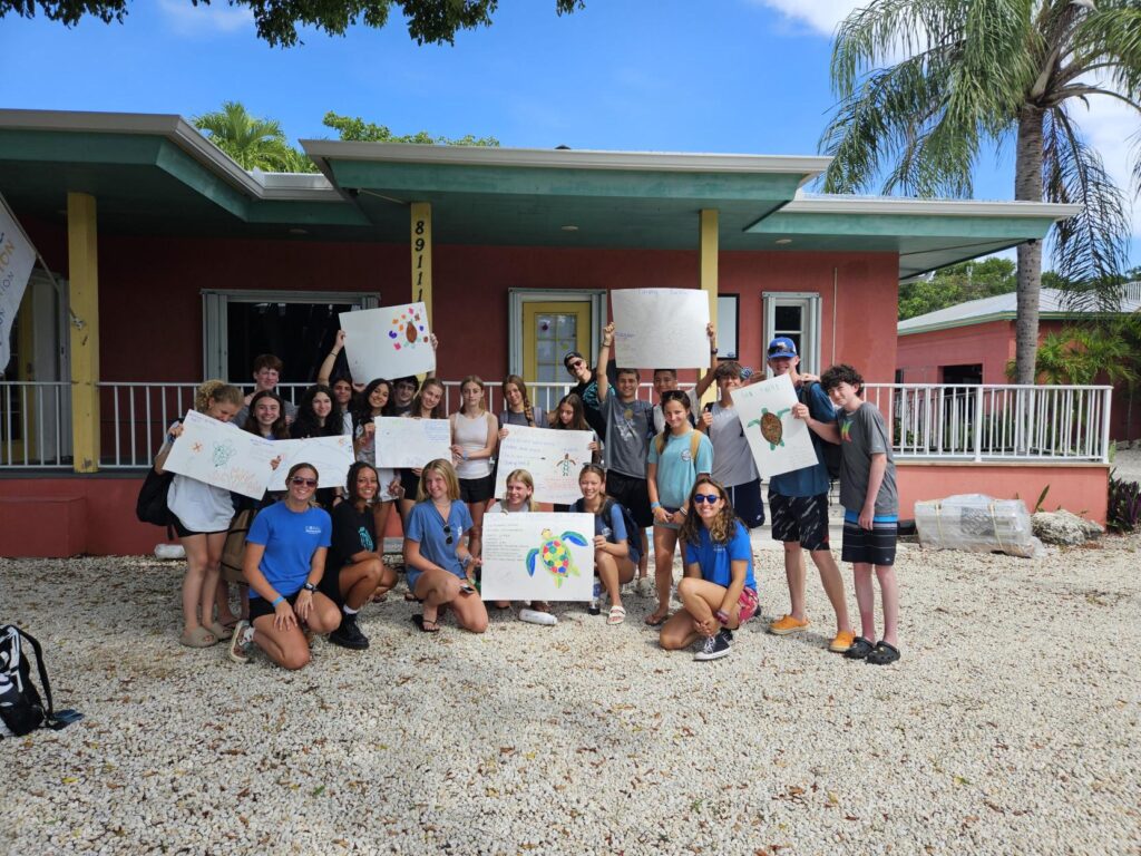 Students displaying their artwork