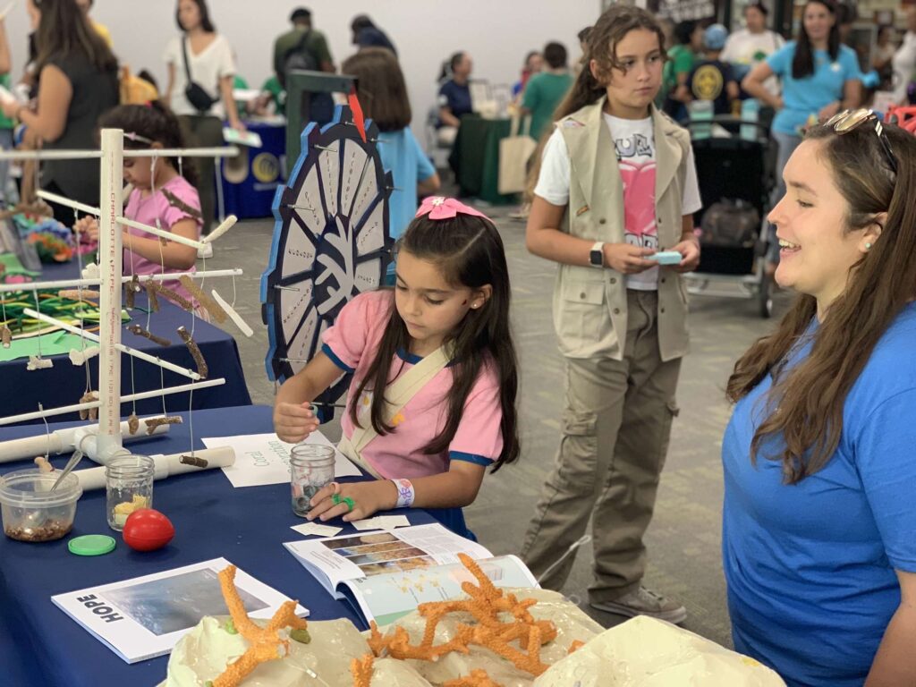 Girl scout practicing coral education experiment