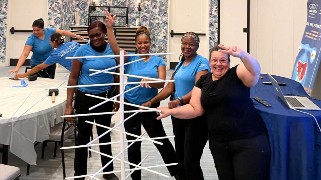 Proud Baker’s Cay Resort employees pose with their completed spiral tree.