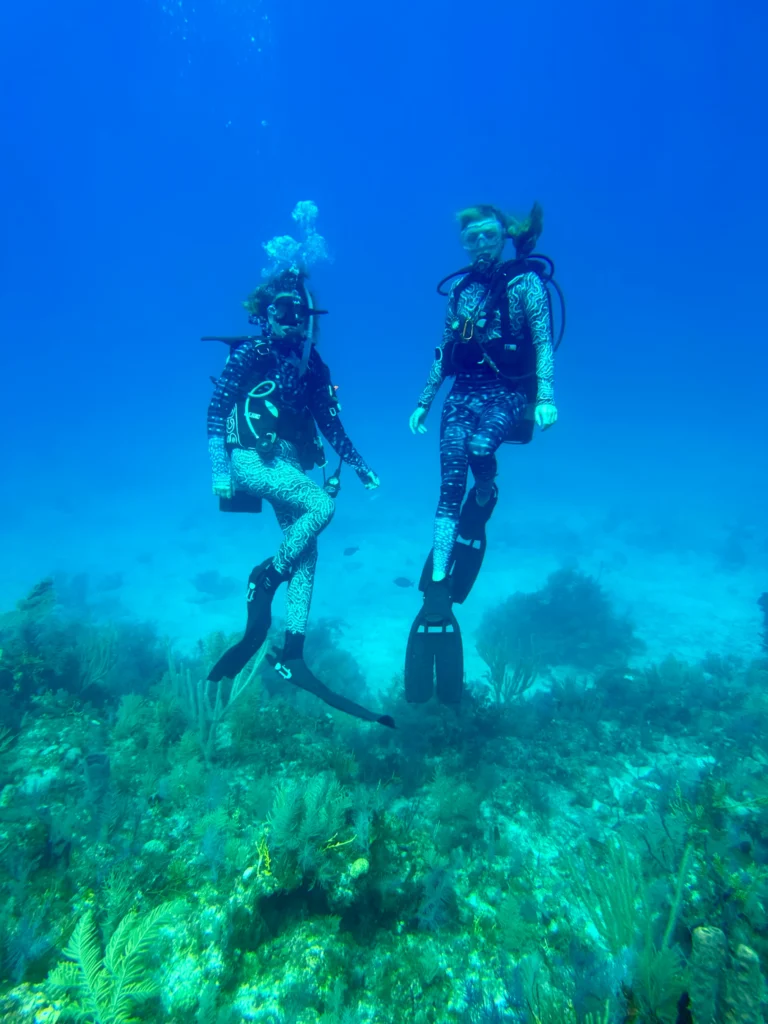 Renate and Chachamovits diving on a coral restoration project.