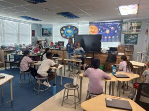 Classroom full of children learning from a Coral Restoration Educator