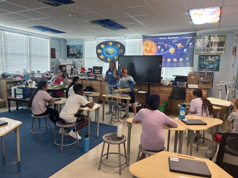 Classroom full of children learning from a Coral Restoration Educator