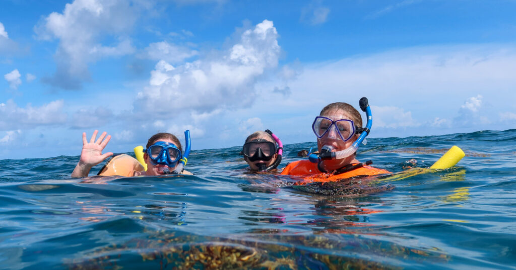 Three educators snorkel near Carysfort Reef in the Florida Keys during the CRF™ and Guy Harvey Foundation educator retreat, exploring coral restoration firsthand.